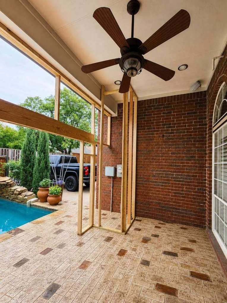 Cobblestone stamp-and-stain field under the porch