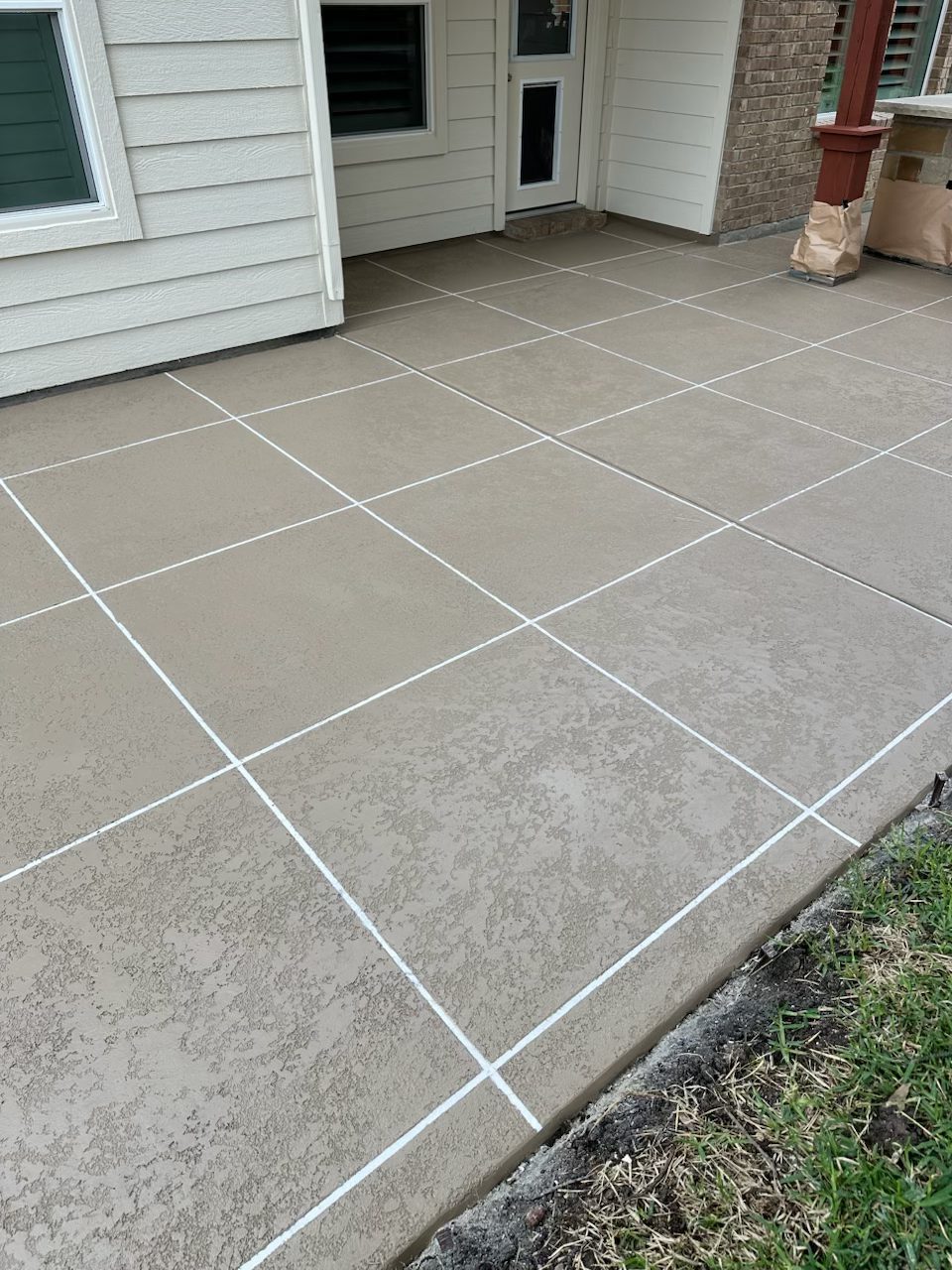 Decorative tile-pattern concrete overlay on patio